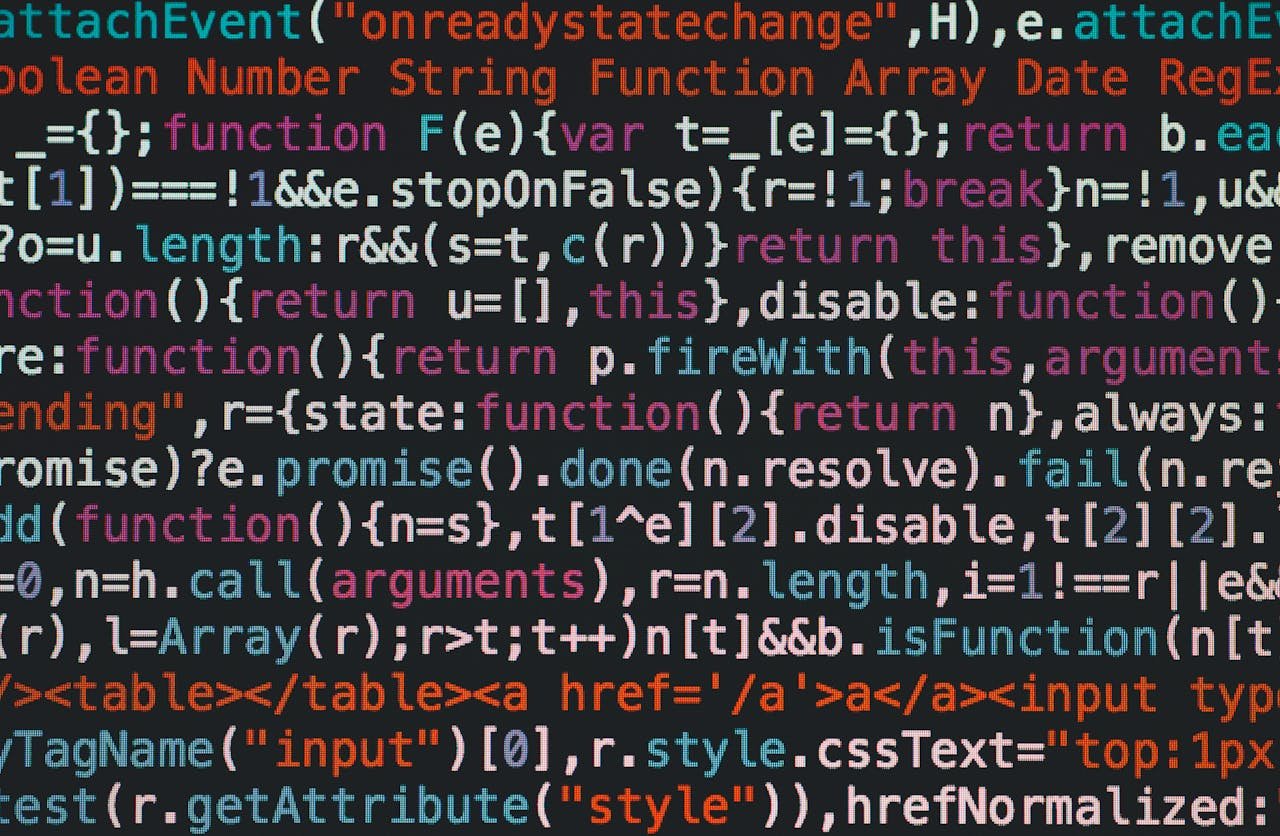 Services Close-up of colorful coding text on a dark computer screen, representing software development.